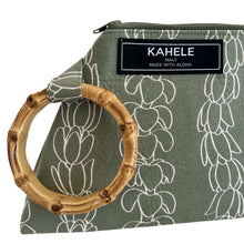 Load image into Gallery viewer, Close up of bamboo handle detail of sage green wristlet with rows of pikake and puakenikeni lei