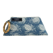 Load image into Gallery viewer, Bamboo handle wristlet with faded denim color with white turtles and tiny fish. Black Kahele Maui brand label on handle side